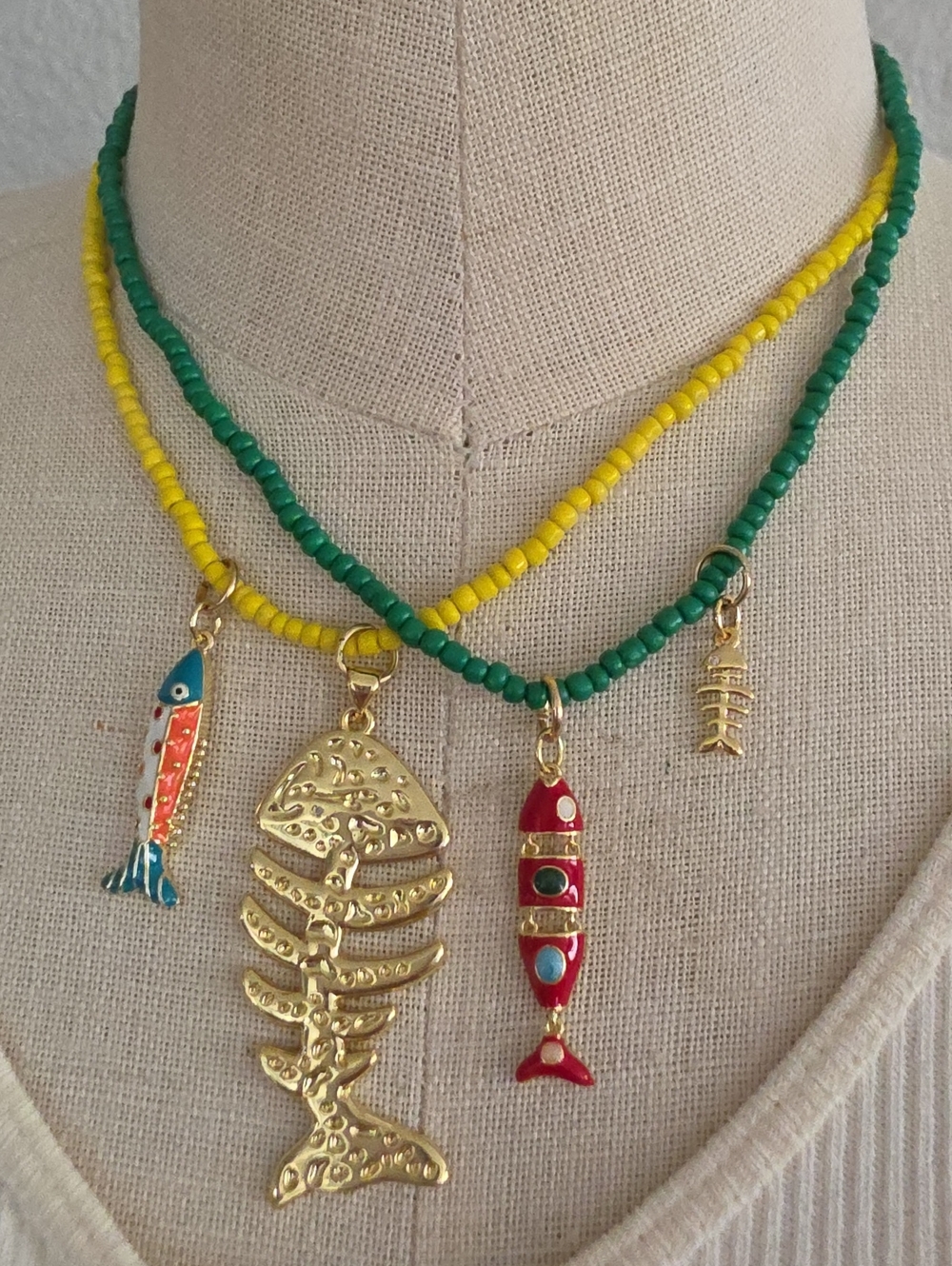 Gold Fishbone Charm Necklace with Green and Yellow Beads